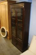 An oak leaded glass double door bookcase