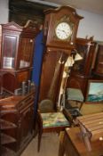 Oak Continental long case clock and a piano stool