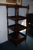 A 19th century mahogany square four tier what not, with single drawer, supported on turned legs with