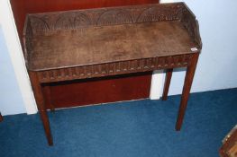 A carved oak side table, 89cm wide