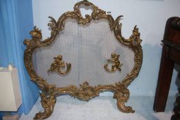 A Continental ornate and wire mesh fire screen, 73cm wide, 70cm height