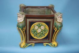 A majolica style jardinière, decorated with scrolls and monkeys, 42cm wide, 38cm high