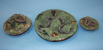 A Portuguese circular majolica snake plate and two smaller plates, 32cm diameter, 21cm diameter,