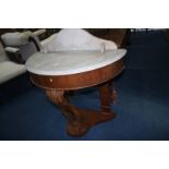 A Victorian half moon marble top washstand