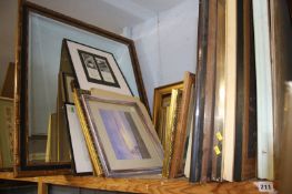 A shelf of framed paintings, prints etc.