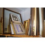 A shelf of framed paintings, prints etc.
