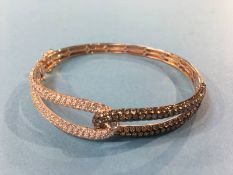 A rose gold bangle, stamped 14kt, mounted with diamonds, (cost £2748), 15.5g