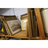 A shelf of framed watercolours, pictures and prints