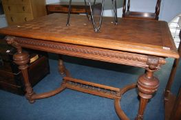 A Continental oak parquetry top table, with carved frieze and legs, 120cm long and 79cm wide