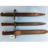 A U.S. 1943 bayonet, a Toledo bayonet and one other