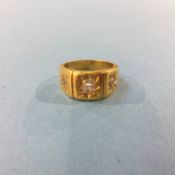 An unmarked gold coloured ring, mounted with three diamonds, 10.7g