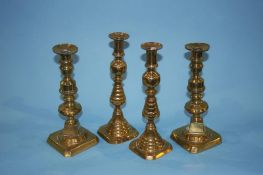 Two pairs of brass candlesticks