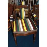 A restored mahogany barbers chair, with leather padded arms and drop in seat