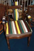 A restored mahogany barbers chair, with leather padded arms and drop in seat