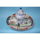 A large Imari wall plaque and a blue and white ginger jar and cover, 46cm diameter