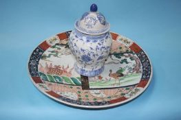 A large Imari wall plaque and a blue and white ginger jar and cover, 46cm diameter