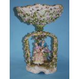 A mid 19th century German porcelain oval table centre piece with lovers seated under an arbour,