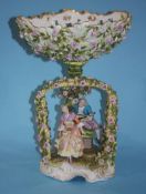 A mid 19th century German porcelain oval table centre piece with lovers seated under an arbour,