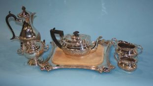 A silver plated cheese board, a water pot, tea strainer and a plated tea set