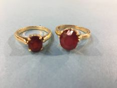 Two rings, stamped 750 and 18k, both mounted with ruby coloured stones, 9.4g