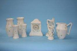 A Belleek clock, two harps and various vases