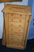 An oak Wellington chest having seven drawers, 48cm wide