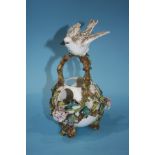 A Continental porcelain floral basket, with a bird resting on the handles