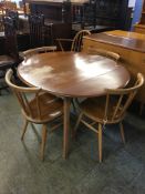 Ercol Golden Dawn flap table and a set of six Ercol Golden Dawn spindle back chairs