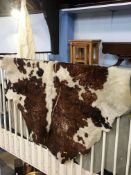 A large cow hide floor rug