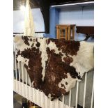A large cow hide floor rug