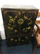 An Oriental lacquered four door painted cabinet