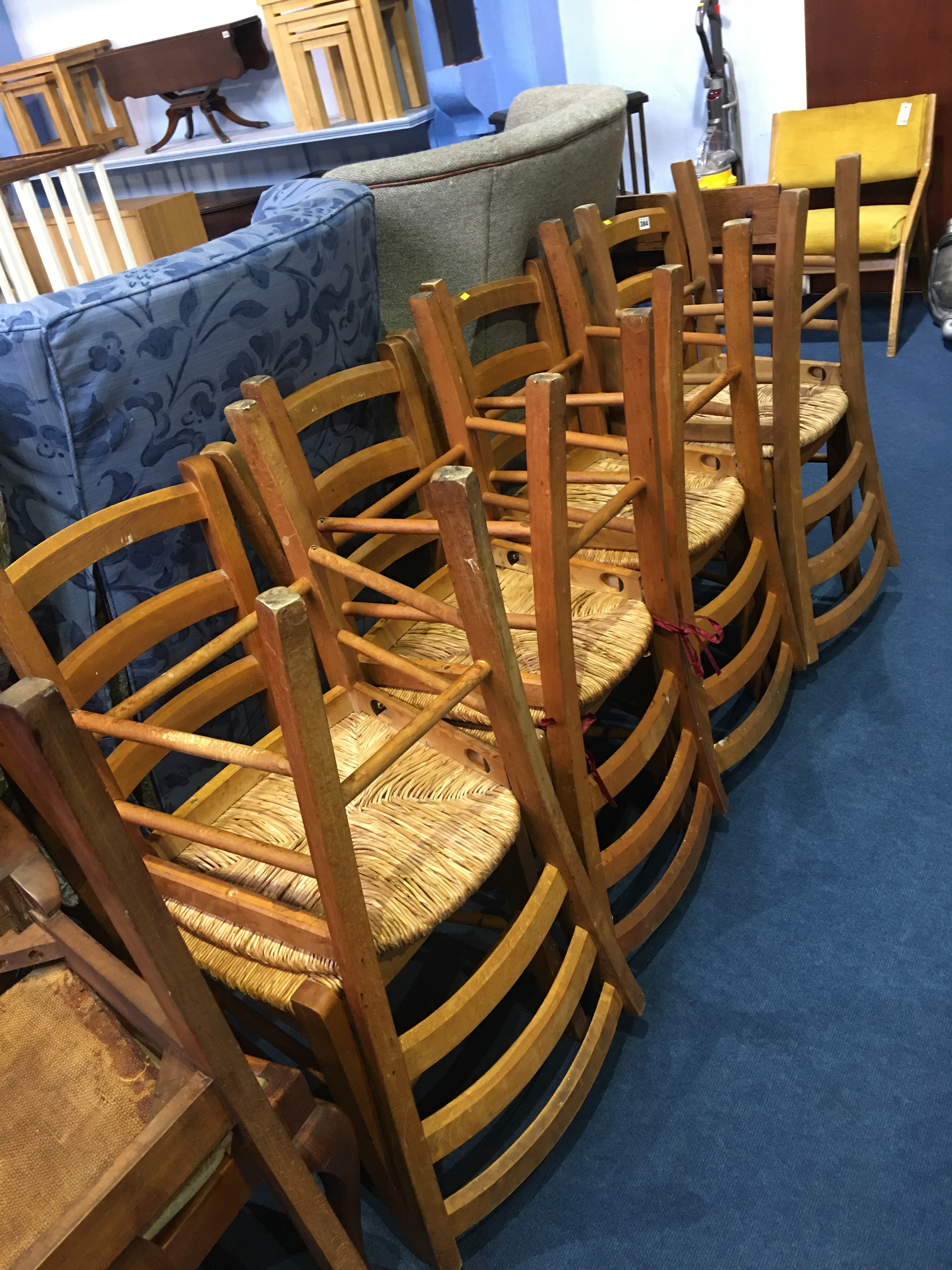 A set of eight ladder back chairs