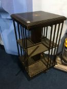 A reproduction mahogany revolving bookcase