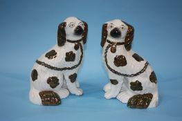 A pair of copper lustre Staffordshire Spaniels