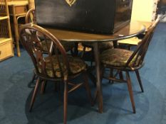 Ercol drop leaf dining table and four wheel back chairs