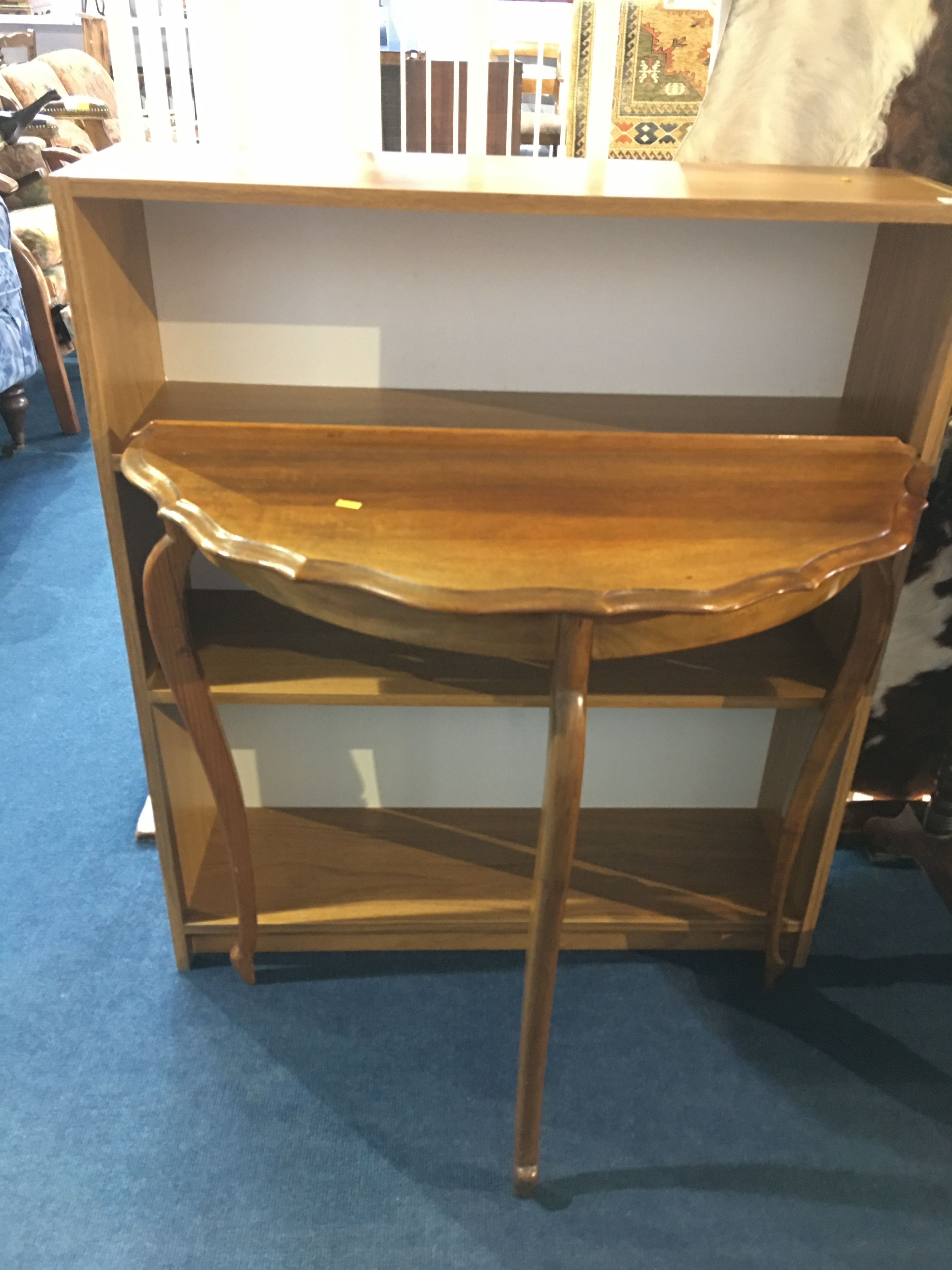 A half moon table and a bookcase