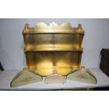 Gold coloured wall shelf and three painted console tables