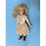 A small Bisque headed doll, approx. 10cm tall