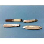 Three mother of pearl fruit knives and a sliver mounted cheroot holder