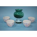 A green glass vase and four tea bowls