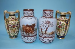 A decorative pair of Noritake vases, 24cm height and a pair of earthenware vases on a pale blue