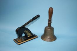 A hand bell and an address stamp