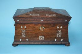 A 19th century rosewood and mother of pearl inlaid tea caddy on bun feet, 31cm