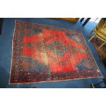 A Persian style rug, the red and blue ground with geometric design, 215cm x 166cm