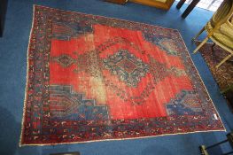 A Persian style rug, the red and blue ground with geometric design, 215cm x 166cm