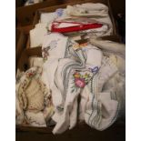 Two boxes of linen and fabrics
