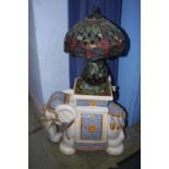 An elephant stool and a Tiffany style lamp