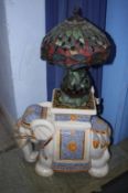 An elephant stool and a Tiffany style lamp