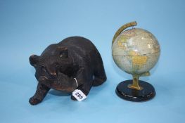 Carved bear and a globe