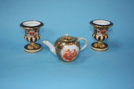 A small Continental miniature teapot, decorated with panels of cherubs, mark in underglaze blue